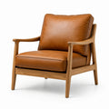 Poltrona in pelle marrone con struttura in legno